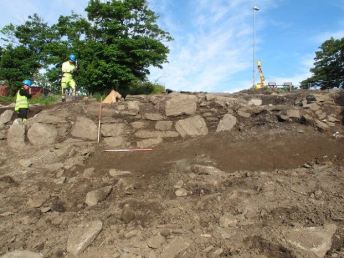 Utgravningsleder Erlend Nordli og feltleder Anette Sand-Eriksen er i gang å fjerne den ene jordbenken som sto igjen inne i ruinen etter utgravningen i 2012. I forgrunnen kan man se østmuren som vender ned mot havnområdet. (Foto: Frida Espolin Norstein, UiO) Utgravningsleder Erlend Nordli og feltleder Anette Sand-Eriksen er i gang å fjerne den ene jordbenken som sto igjen inne i ruinen etter utgravningen i 2012. I forgrunnen kan man se østmuren som vender ned mot havnområdet. (Foto: Frida Espolin Norstein, UiO)