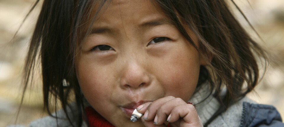 Et barn tilhørende minoritetsgruppen Yi i Sichuan-provinsen i Kina. Røykende barn er ikke uvanlig i en del asiatiske land.  (Foto: Joe Chan, Reuters/NTB scanpix)