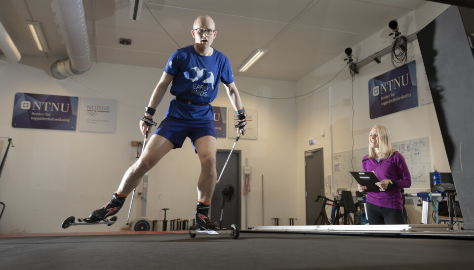 Professor og langrennsløper Øyvind Sandberg ved NTNU er utstyrt med sensorer mens han tester ulike delteknikker for langrenn på tredemølla. Forsker Trine Seeberg i SINTEF samler data fra sidelinja. (Foto: Thor Nielsen)