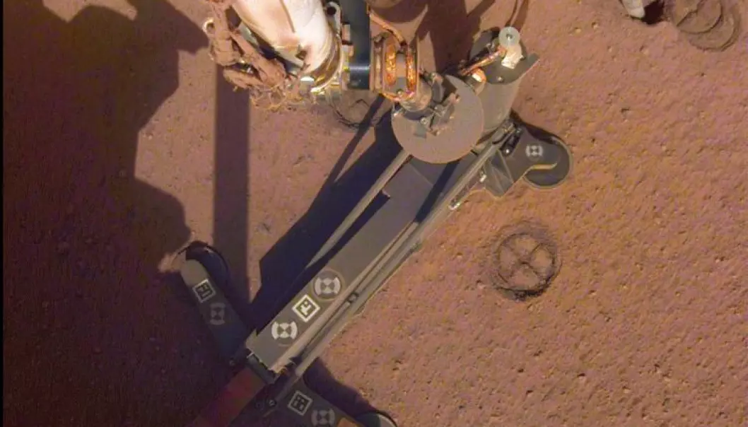 28. juni tok InSight dette bilde. Her løfter robotarmen av en del av muldvarpen. Her på jorda var forskerne kjempeglade for at det gikk. (Foto: NASA/JPL-Caltech)
