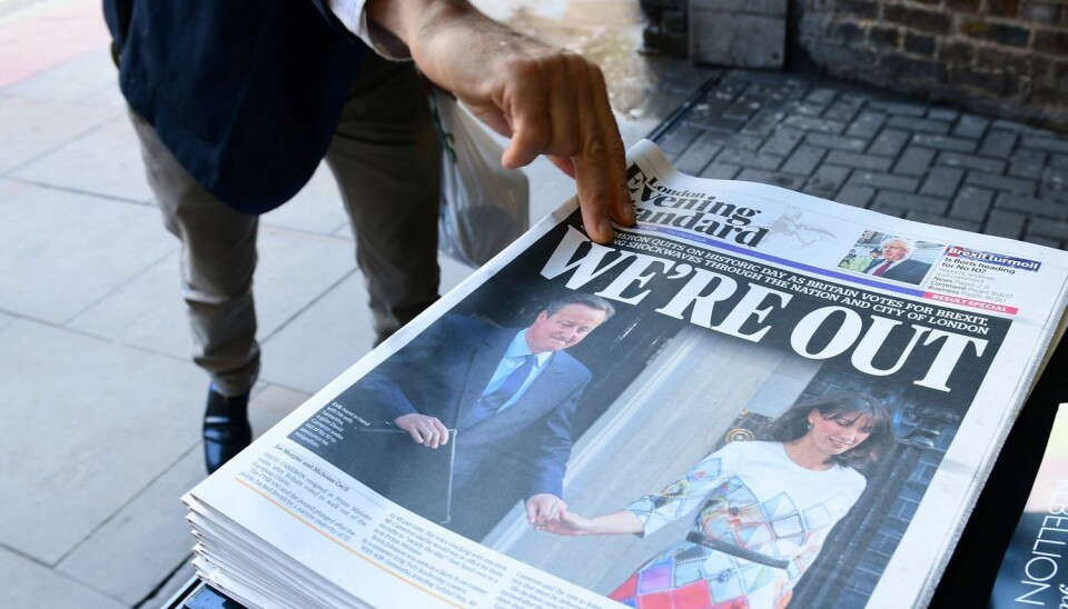 En mann plukker med seg en utgave av London Evening Standard. David Cameron går av etter nederlaget i folkeavstemningen i går, der et flertall stemte for at Storbritannia skal ut av EU. Dette kan føre til at også økonomien går nedover, mener norsk økonomiforsker.  (Foto: AFP/NTB/Scanpix)