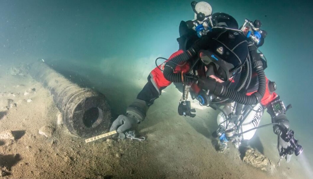 En dykker undersøker en av kanonene på skipsvraket. (Foto: Kirill Egorov / Ocean Discovery / Mars Project) En dykker undersøker en av kanonene på skipsvraket. (Foto: Kirill Egorov / Ocean Discovery / Mars Project)