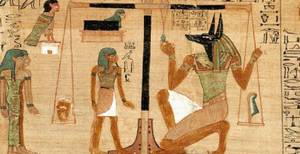 Seremonien der hjertet veies av begravelsesguden Anubis med sjakalhodet.
Detalj fra Ani papurys, ca 1275 f.v.t. (Foto: British Museum)