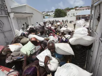 Internally displaced Somali people squeeze through a narrow gate with food relief delivered by the Algerian government for drought victims, in Hodan district, south of Mogadishu, August, 2011. (Photo: Feisal Omar/REUTERS)