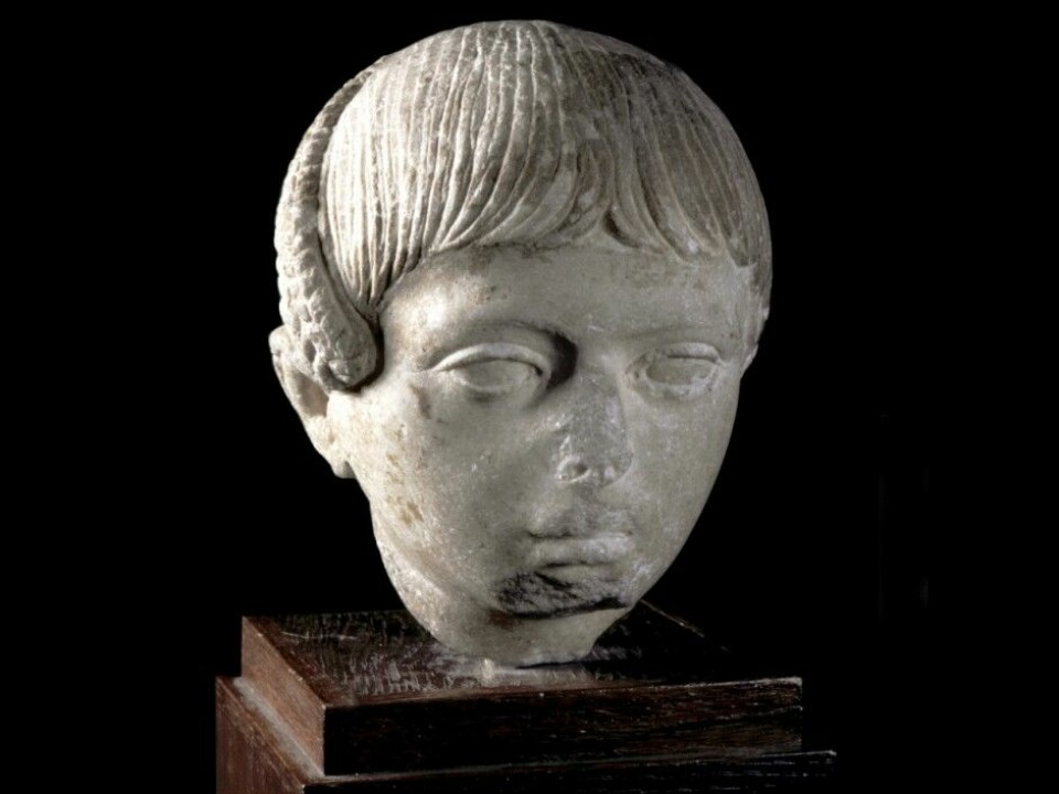 Sculpture of a Roman boy with his hair worn in the Egyptian style with a “lock of Horus”. The side-lock of hair was cut off and dedicated to the gods in connection with the coming-of-age ceremony marking the transition to adult life. From the first half of the second century CE. Museum of Cultural History, Oslo. (Photo: Museum of Cultural History)