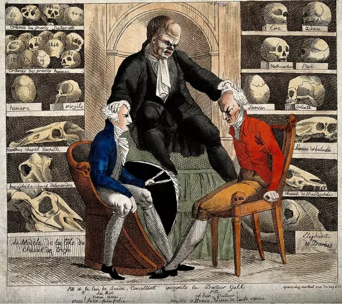 En karikatur av dr. Gall fra 1806. Omringet av berømte hodeskaller, undersøker Gall hodene til William Pitt den yngre og Gustav IV Adolf, kongen av Sverige. Tegnet av  (Foto: (Bilde: Wellcome Library/Wikimedia Commons.))