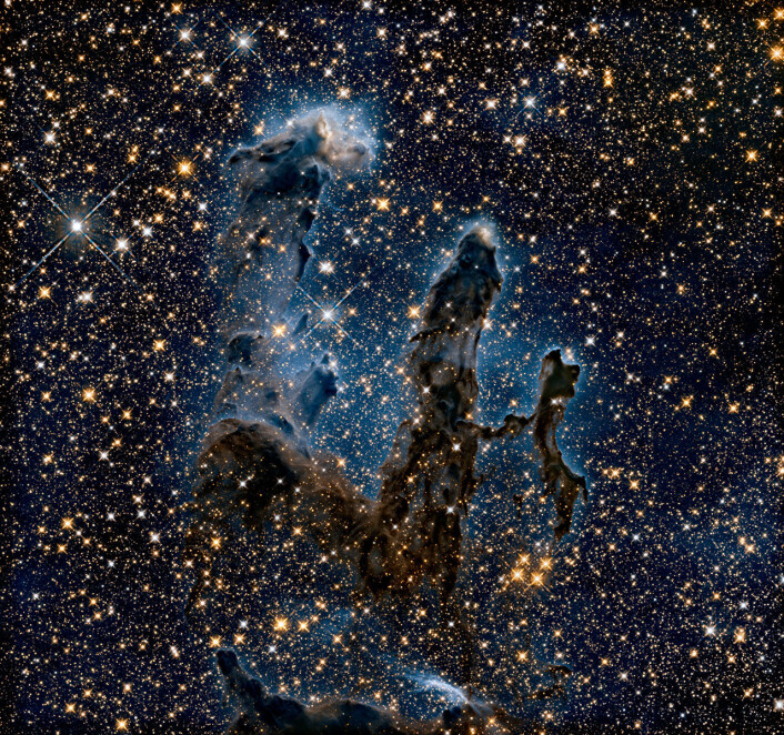 Det nye bildet, sett i infrarødt lys. Her kunne forskerne se at tårntoppene består av tette ansamlinger med gass og støv. (Foto: NASA, ESA/Hubble and the Hubble Heritage Team) Det nye bildet, sett i infrarødt lys. Her kunne forskerne se at tårntoppene består av tette ansamlinger med gass og støv. (Foto: NASA, ESA/Hubble and the Hubble Heritage Team)