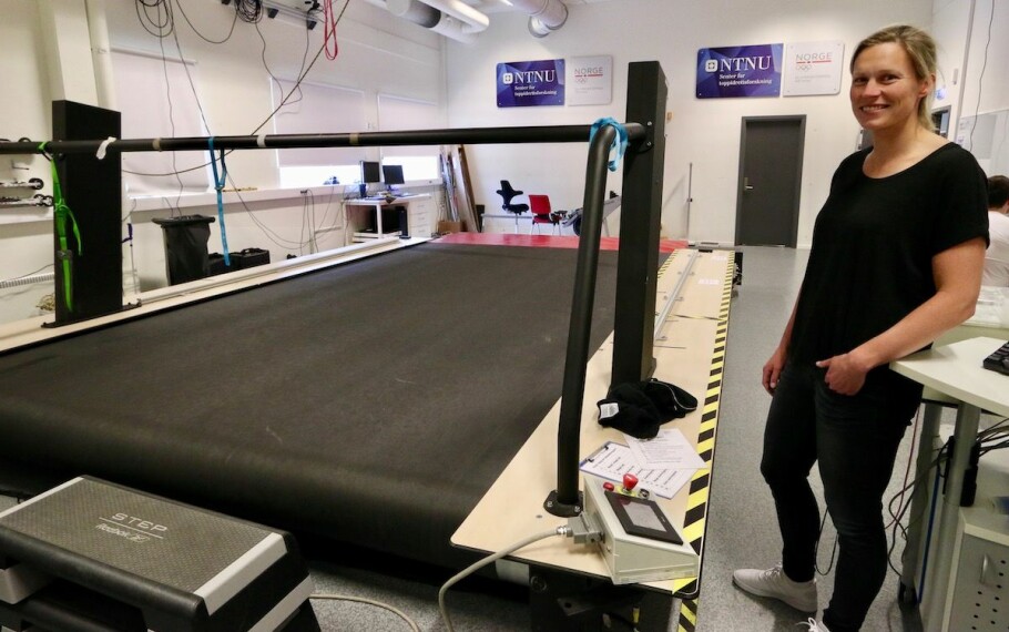 Guro Strøm Solli next to the giant treadmill where Bjørgen and other elite skiers are sometimes tested. The size of the treadmill allows the skiers to use roller skis while researchers measure different vital signs. (Photo: Nancy Bazilchuk / NTNU)