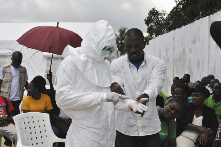 Helsearbeider i aksjon blant befolkningen i Liberia. (Foto: Scanpix/Reuters) Helsearbeider i aksjon blant befolkningen i Liberia. (Foto: Scanpix/Reuters)