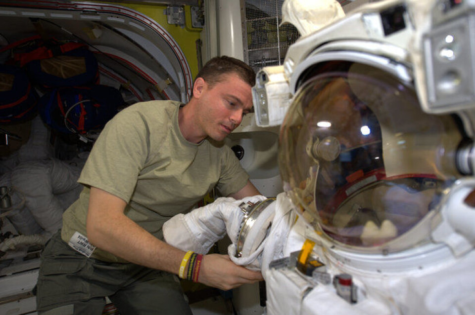 NASAs astronaut Reid Wiseman forbereder romdrakten han skal ha på seg under romvandringen sammen med Alexander Gerst. (Foto: NASA/ESA)