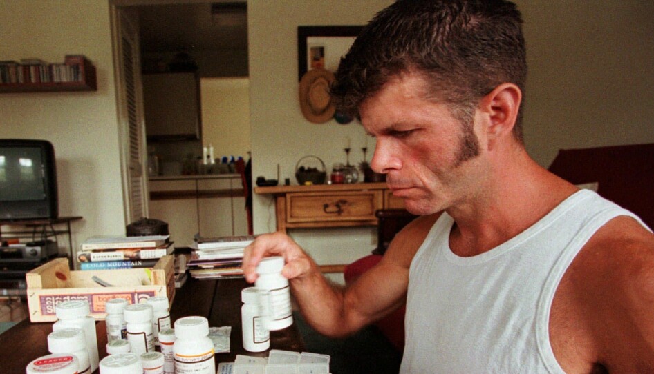 In this Aug. 14, 1998 file picture, Michael Willis sorts out his medicine in his Baltimore apartment. Willis is one of thousands of Americans who were rescued from the brink of death by the advent of the AIDS cocktail, a combination of pills that turned a uniformly lethal disease into a treatable one. These days, the number of pills an HIV patient needs to take has dropped dramatically, but long-term treatment has led to other health problem, including a phenomenon called inflam-aging.