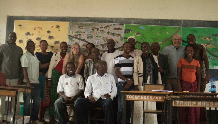 Participants stand in front of four posters showing possible future scenarios. The posters were used to encourage participants to discuss what they wanted for their own futures. Participants stand in front of four posters showing possible future scenarios. The posters were used to encourage participants to discuss what they wanted for their own futures.