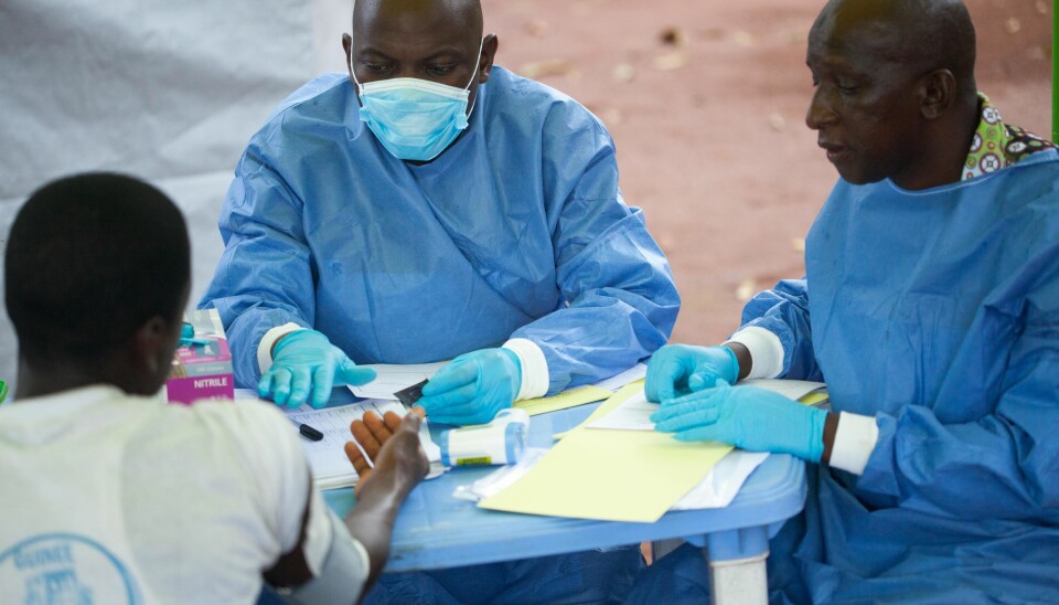 WHO health personnel treat a patient during the Ebola outbreak in Guinea. As WHO increasingly works locally, it is important to incorporate cultural contexts in clinical guidelines and policy.