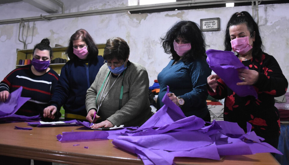 Armenian Syrian volunteers sew masks to distribute to the poor for protection against the coronavirus pandemic, in Syria's northern city of Aleppo, on March 27, 2020.