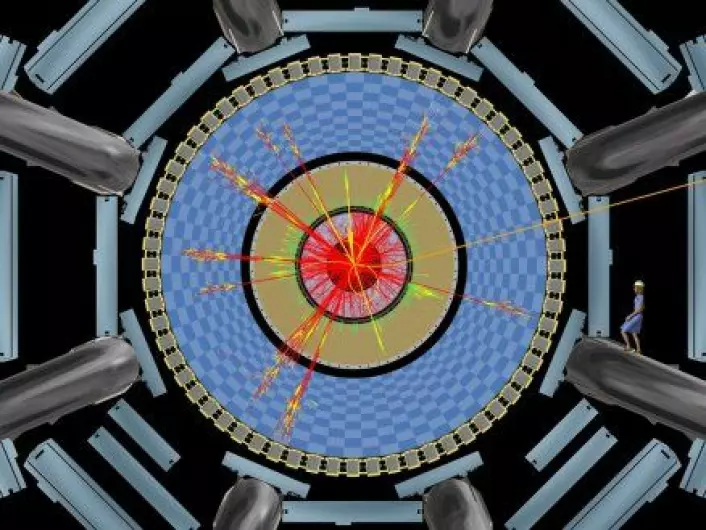 "Denne illustrasjoner viser en simulering av hvordan en partikkelkollisjon som skaper et sort hull vil registreres i detektoren ATLAS. Kvinnen til høyre illustrerer størrelsen på detektoren."