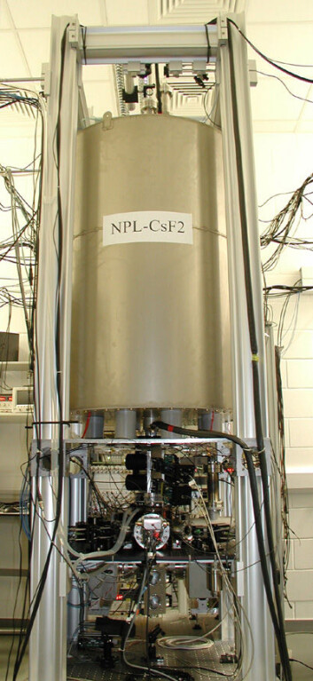 Klokka NPL-CsF2 som står i National Physical Laboratory i Teddington, Storbritannia. Hele apparatet er omtrent 2,5 meter høyt. Atomene kastes en meter opp, omtrent 30 cm over hulrommet som befinner seg inne i en vakuumbeholder. Den store ytre sylinderen beskytter atomene inne i klokken fra det relativt store og ustabile magnetfeltet. (Foto: National Physical Laboratory, United Kingdom) Klokka NPL-CsF2 som står i National Physical Laboratory i Teddington, Storbritannia. Hele apparatet er omtrent 2,5 meter høyt. Atomene kastes en meter opp, omtrent 30 cm over hulrommet som befinner seg inne i en vakuumbeholder. Den store ytre sylinderen beskytter atomene inne i klokken fra det relativt store og ustabile magnetfeltet. (Foto: National Physical Laboratory, United Kingdom)