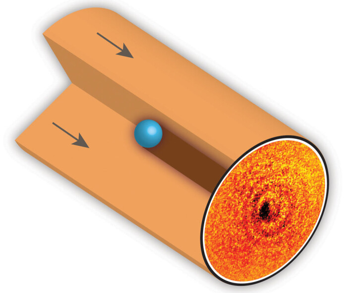 Atomet ble holdt fast av elektriske felter, slik at forsknerne fikk knipset bildet av skyggen dets. (Foto: (Illustrasjon: Griffith University)) Atomet ble holdt fast av elektriske felter, slik at forsknerne fikk knipset bildet av skyggen dets. (Foto: (Illustrasjon: Griffith University))