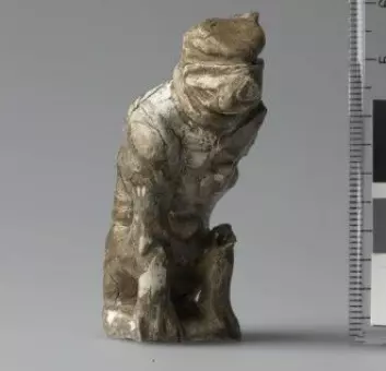 A six-centimetre tall figurine that possibly portrays a bear. It was found in a tomb in Østre Alm, Hedmark county, with two other, smaller game pieces. The bear figurine was probably used as the main piece in a game of hnefatafl.