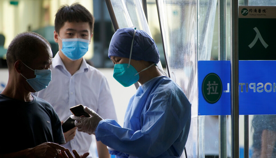 A nurse in Wuhan, China uses a smart phone for work. Health professionals in China have embraced the WeChat app to communicate with colleagues on the other side of town, or the globe.