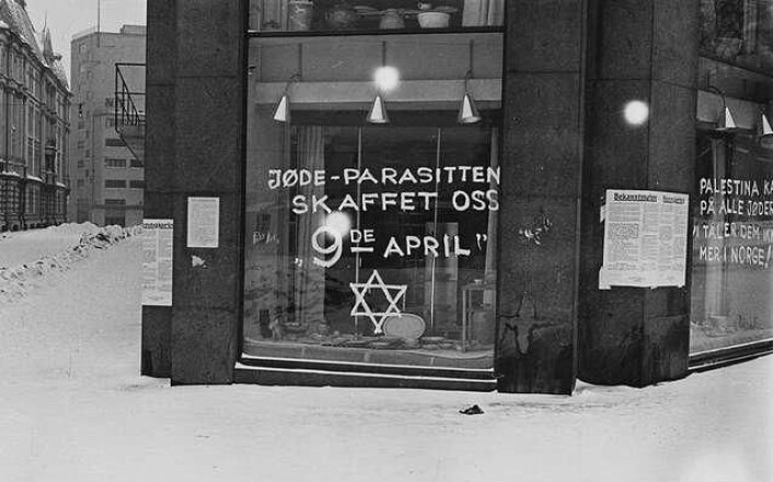 Antisemittisk grafitti på et butikkvindu i Oslo i 1941. Teksten på vinduet i forgrunnen sier "Jøde-parasitten skaffet oss 9de april". På ruta rundt hjørnet står "Palestina kaller på alle jøder. Vi tåler dem ikke mer i Norge". (Foto: Anders Beer Wilse (1865–1949)/Wikimedia Commons) Antisemittisk grafitti på et butikkvindu i Oslo i 1941. Teksten på vinduet i forgrunnen sier "Jøde-parasitten skaffet oss 9de april". På ruta rundt hjørnet står "Palestina kaller på alle jøder. Vi tåler dem ikke mer i Norge". (Foto: Anders Beer Wilse (1865–1949)/Wikimedia Commons)