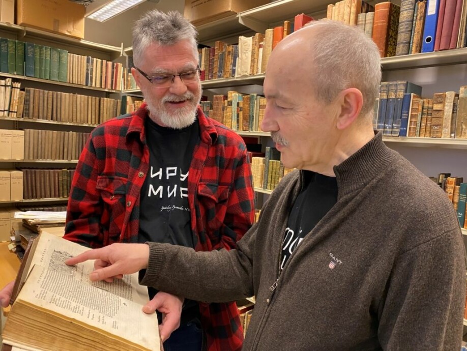 Bibliotekar Ivar Stokkeland (t.v.) og historiker Rune Blix Hagen med bokverket Historien om de nordiske folk.