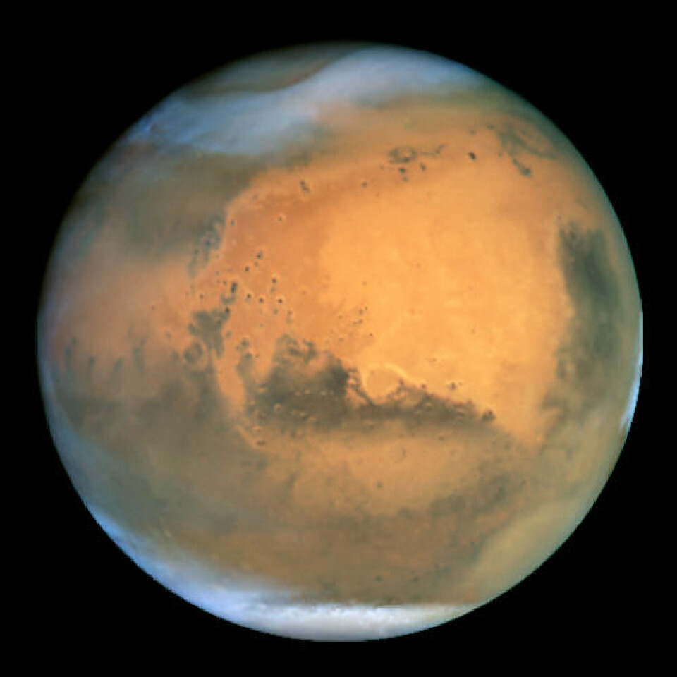 Mars, sett fra avstand. Nærmere enn dette kommer nok ikke menneskelige øyne i løpet av de neste tiårene. (Foto: NASA)