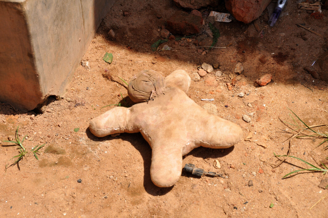 A handmade doll on a dirt road in an urban slum in Uganda. A handmade doll on a dirt road in an urban slum in Uganda.