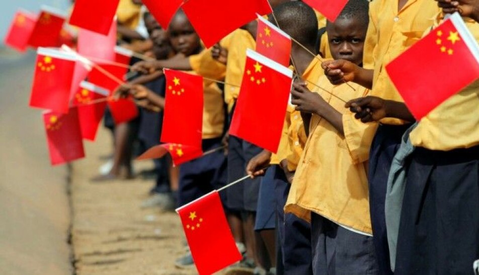 Liberian children holding Chinese flags during a visit by China's former president, Hu Jintao, to Monrovia in 2007.