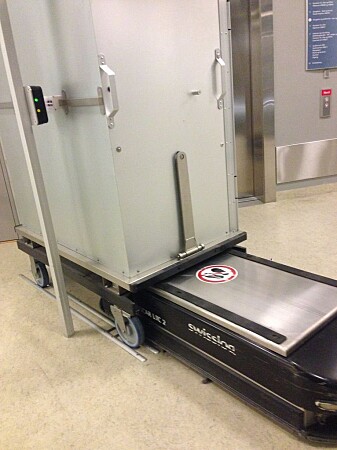 St. Olavs Hospital was the first hospital in Scandinavia to adopt the use of simple transport robots in the hospital buildings. The photo shows one of the robots loading a cart. St. Olavs Hospital was the first hospital in Scandinavia to adopt the use of simple transport robots in the hospital buildings. The photo shows one of the robots loading a cart.