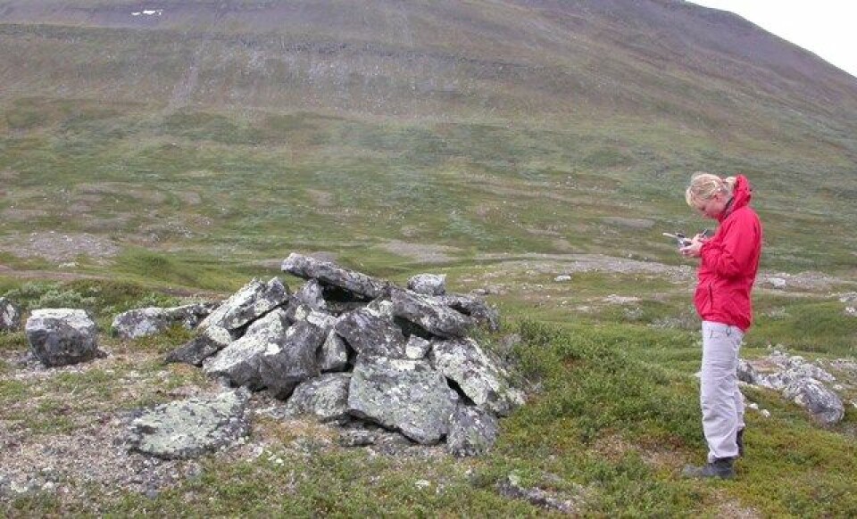 Arkeolog Stine Barlindhaug registrerer en førkristen samisk urgrav i Porsangermoen - Halkavarre skytefelt. (Foto: Alma Thuestad, NIKU)