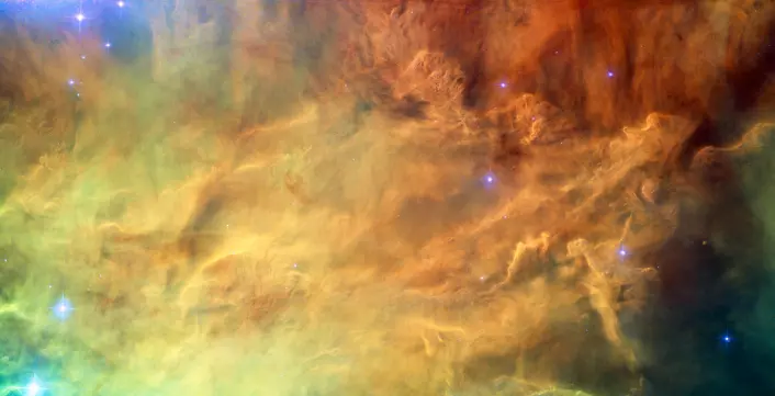 Ei enorm sky av glødande støv og gass inne i «Lagunetåka». (Foto. NASA, ESA)