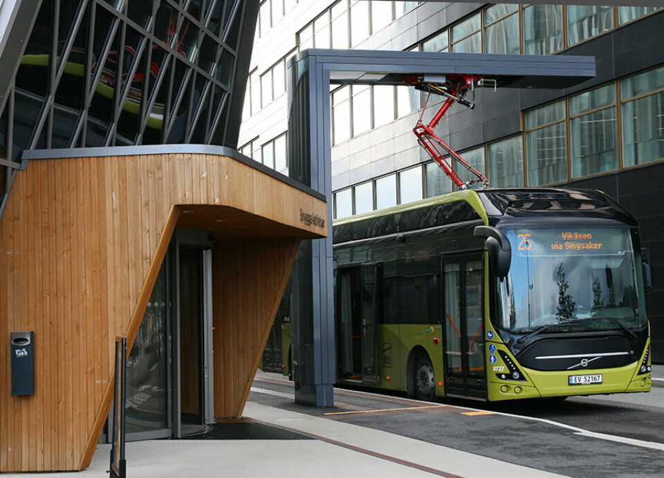 A charging station for electric buses is located between the plus-energy buildings.