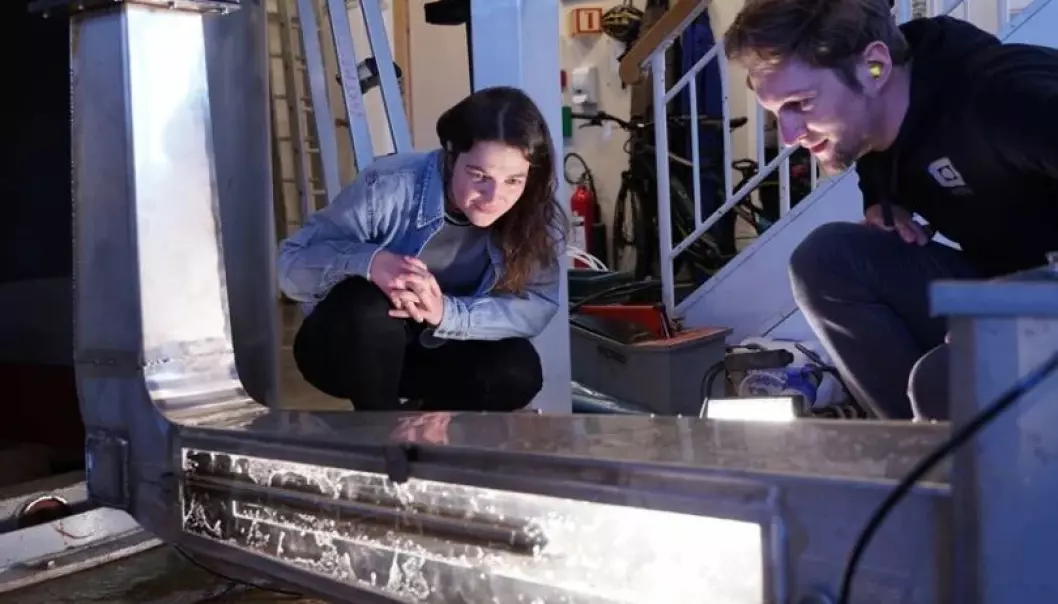 Vera Gütle (left) who recently completed her master’s degree, and Wolf Ludwig Kuhn (right), a PhD candidate, look at a channel in the Waterpower Laboratory where they have studied ways to remove dissolved air from supersaturated water around hydropower plants