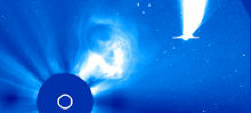 'Oppe til høyre ser du kometen C/2002 V1 (NEAT) fotografert fra SOHO den 18.02.2003. Sirkelen til venstre dekker Sola, som er 1,4 millioner kilometer bred, eller 109 ganger bredere enn jordkloden. Streken tvers over kometens hode skyldes at lysstyrken metter instrumentene på SOHO. (Foto: SOHO/ESA/NASA)'