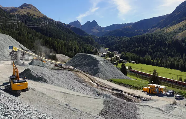 Bildet viser en byggeplass til den nye Albulatunnelen i Sveits. Her ble massene brukt som tilslag til betongproduksjon og som ballast; underlag av pukkstein for jernbanesviller.
