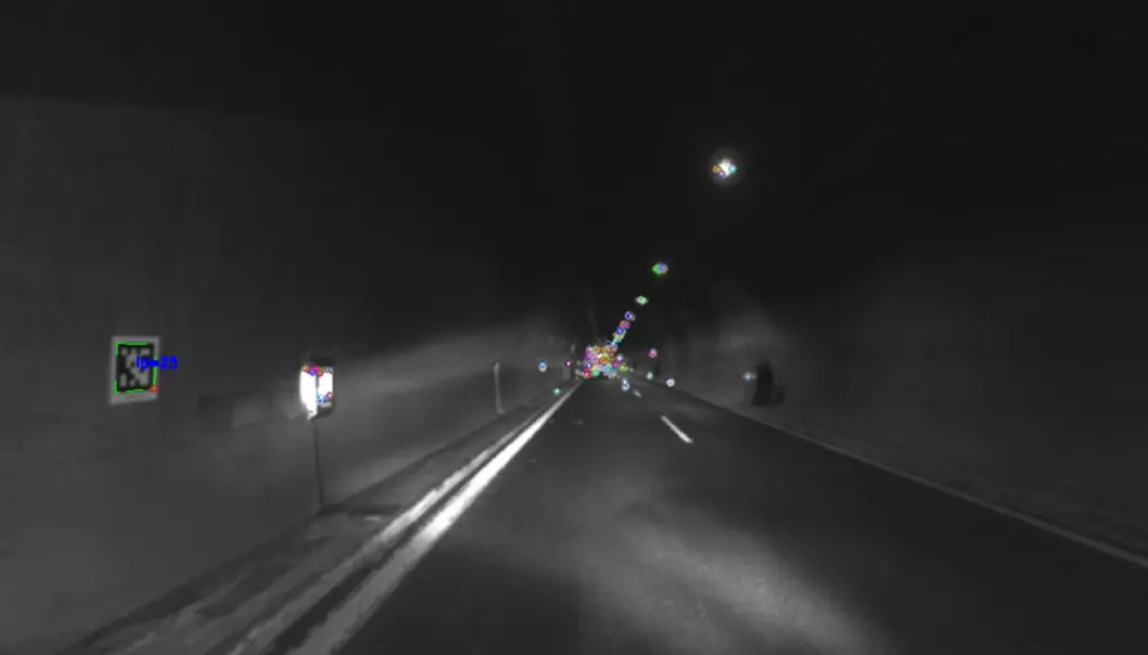 This photo was taken using a camera mounted on a robot vehicle. The robot navigates through the tunnel using a series of markers (shown in colour in the photo). The markers are then processed by a positioning algorithm.