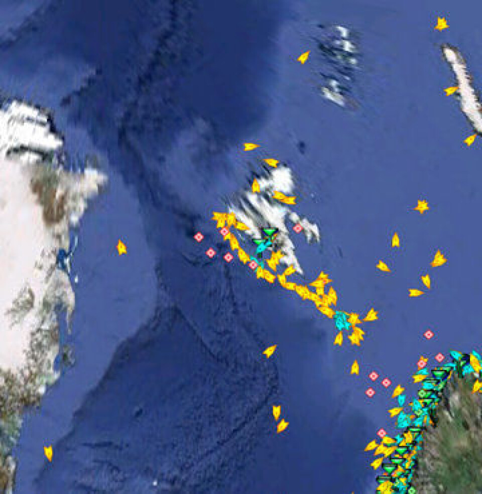 AISSat-1 registrerer skipsposisjoner (gult/rødt) langt til havs og opp mot iskanten. Blått/grønt er registrert fra landbaserte AIS-stasjoner. (FFI)