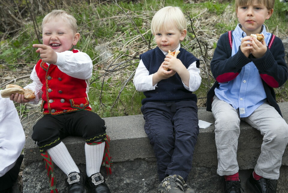 Barn som spiser pølse på 17. mai.