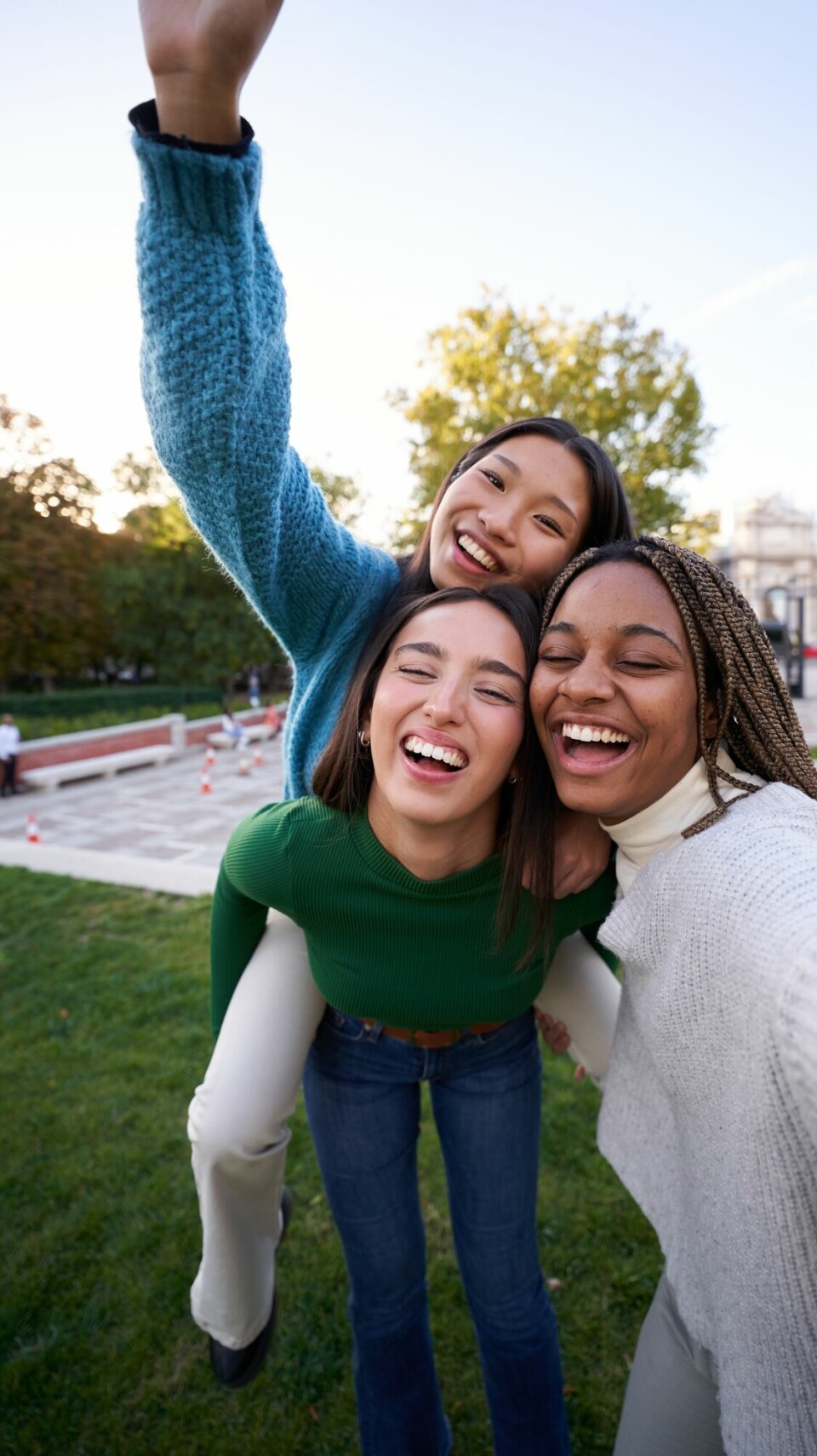 Vertical,Photo,Of,Three,Multicultural,Female,Friends,Taking,Smiley,Selfie