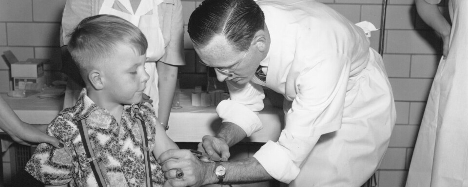 Dr. Richard Mulvaney of Mclean injects the new polio vaccine into the arm of six-year-old Randall Kerr, the first of some 100 children to be innoculated at McLean in Washington, D.C. on April 26, 1954.  The vaccine against poliomyletis is being tested in selected areas across the nation.  (AP Photo)