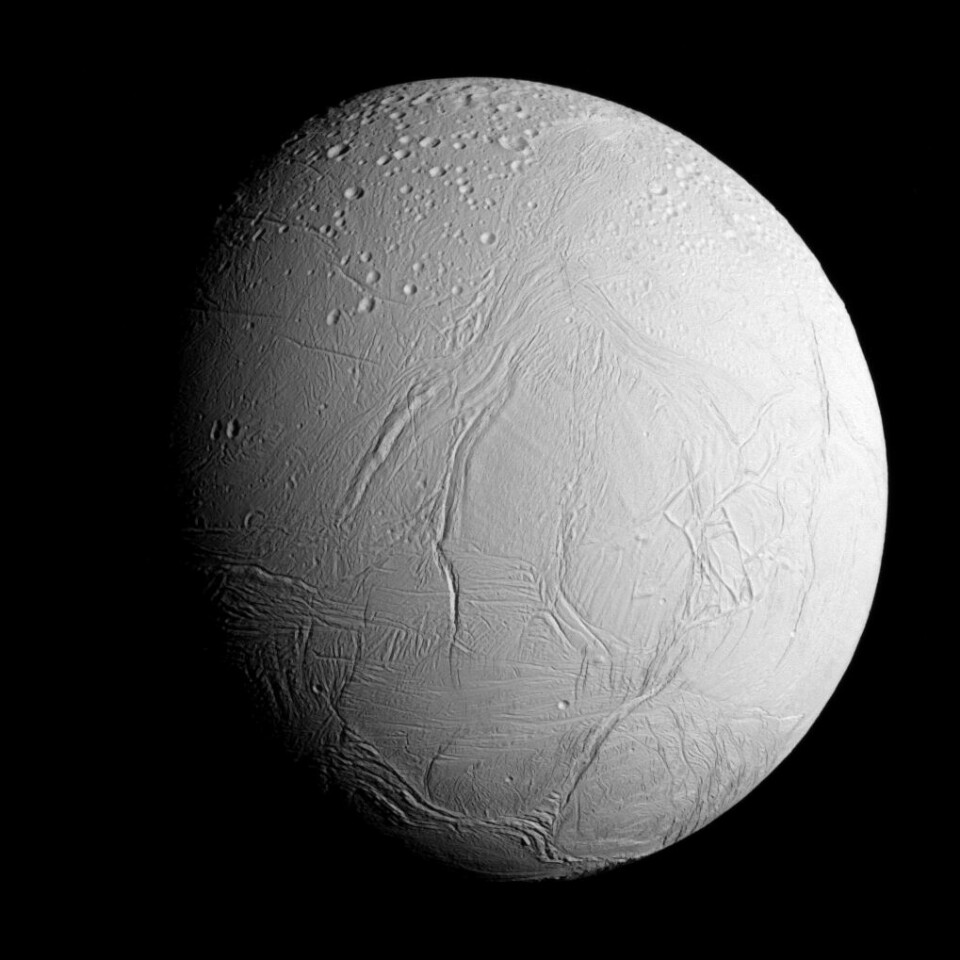 Here you can clearly see how Enceladus' icy surface is smooth and without many craters.  The moon has also been seen by Cassini.