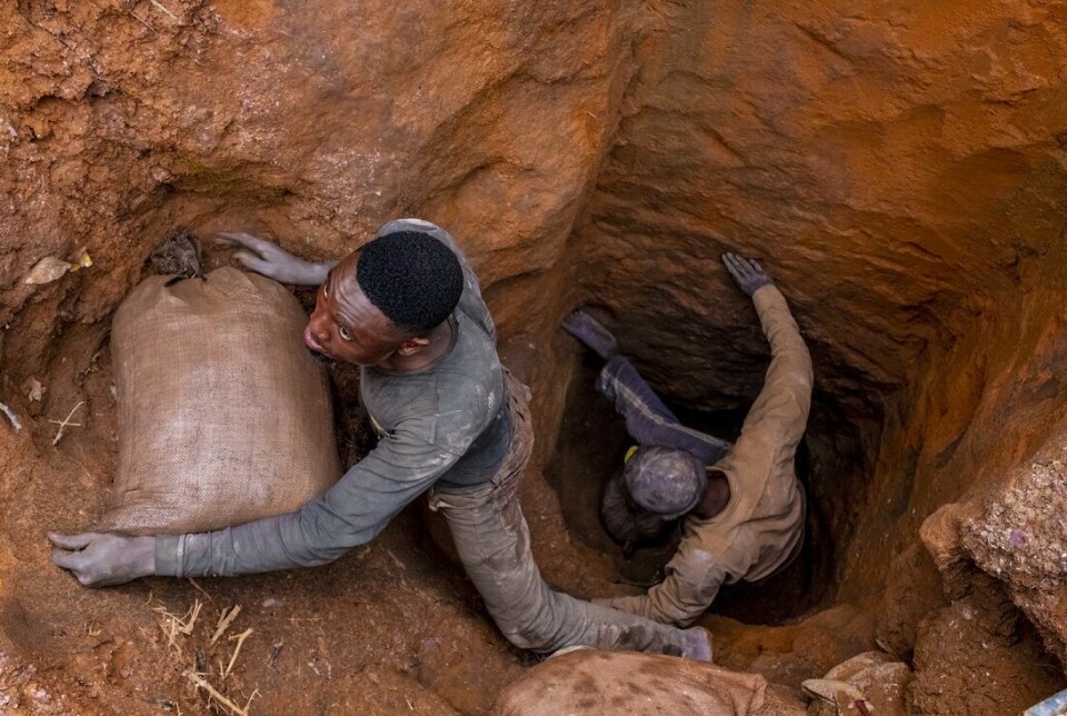 To arbeidere lemper sekker ut av gruve.