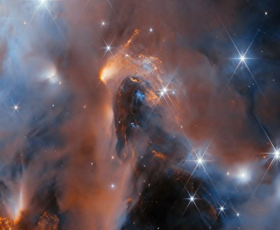 Romteleskopet James Webb tok nylig dette bildet av stjernetåka NGC1333. Den ligger tusen lysår fra jorda. En enorm rosa og blå tåkesky i rommet. Noen klare skinnende stjerner er strødd rundt skyen.