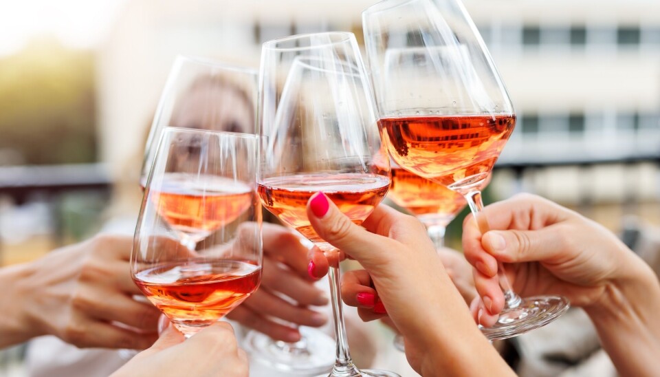 Alkohol øker kvinners risiko for å utvikle brystkreft. Drikk så lite som mulig, sier flere. Ikke drikk i det hele tatt, er den nye anbefalingen til World Cancer Research Fund. Kvinnehender holder i alt seks glass med rosévin som holdes sammen i en skål.