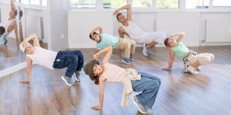 Physical activity is also important for mental health. Kids and an adult appear to be dancing in a studio.