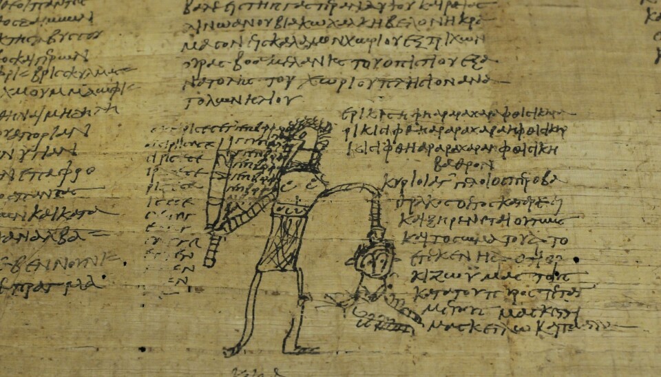 Trolldomformel med tegning. Strektegning på en gammel papyrus.