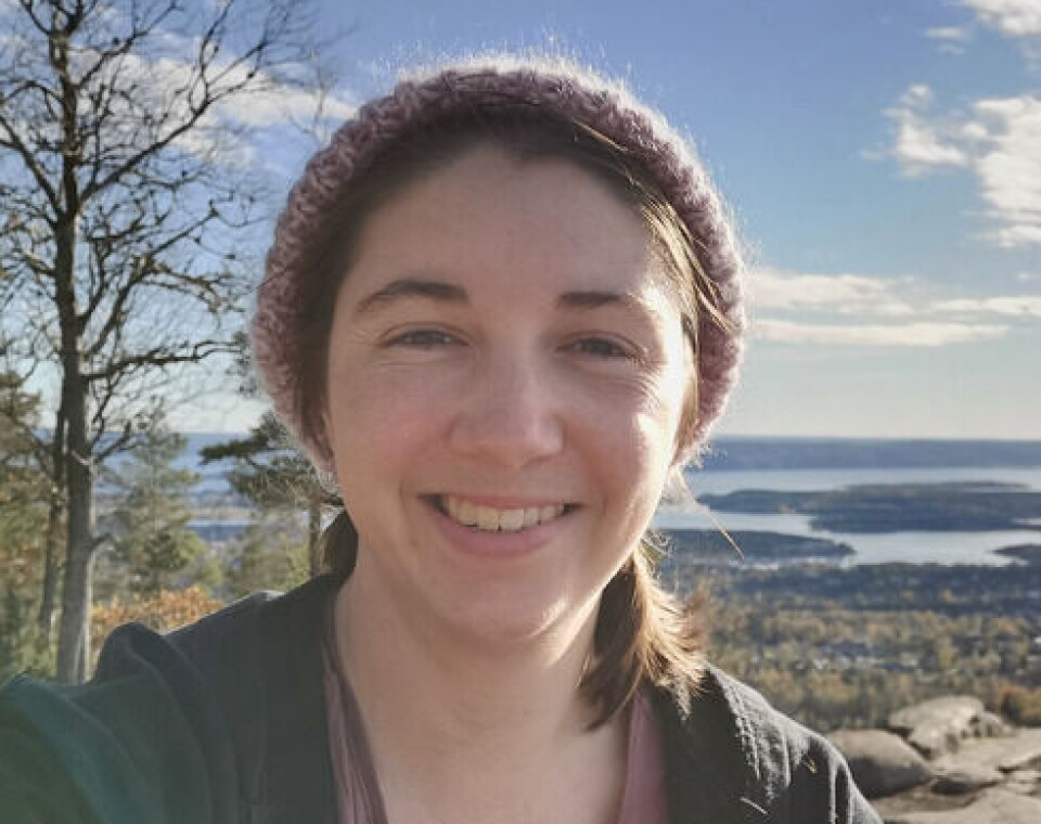 Edena Jean Lord er fra New Zealand, men flyttet til Sverige for å forske på lemen. Kvinne smiler til kamera med natur bak seg.