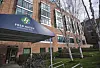 Murbygning med skiltet Fred Hutch Cancer Center. Det står sykler og trær utenfor bygget i Seattle.